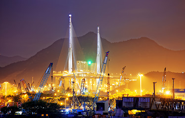 Image showing Container Cargo freight ship with working crane bridge