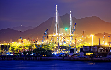 Image showing Container Cargo freight ship with working crane bridge