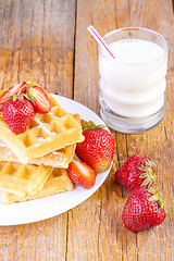 Image showing homemade waffles with strawberries maple syrup
