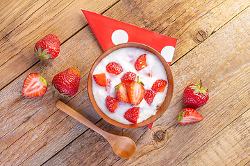 Image showing fresh organic greek yogurt with strawberries on wooden