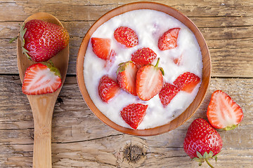 Image showing fresh organic greek yogurt with strawberries on wooden 