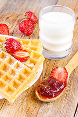 Image showing homemade waffles with strawberries maple syrup