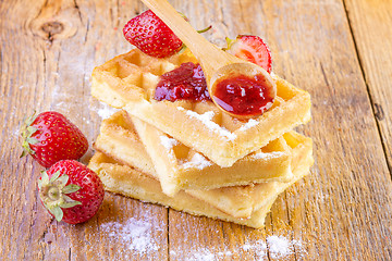 Image showing homemade waffles with strawberries maple syrup