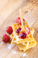 Image showing homemade waffles with strawberries maple syrup