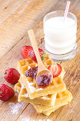 Image showing homemade waffles with strawberries maple syrup