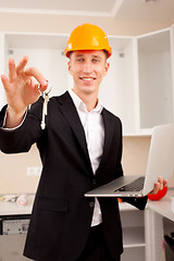 Image showing smiling engineer gives keys