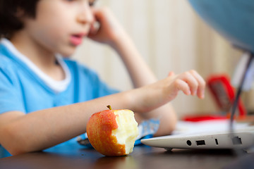 Image showing bitten apple and a boy with computer