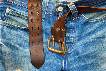 Image showing aged jeans with unfastened belt