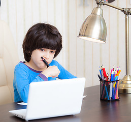 Image showing boy doing homework with computer