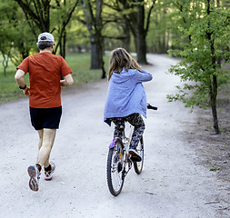 Image showing Dad with daughter on bike 