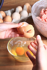 Image showing crashing eggs for preparing food