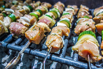 Image showing shish kebab on skewers on a grill on a holiday