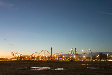 Image showing sunset over an amusement park in a distance