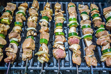 Image showing shish kebab on skewers on a grill on a holiday