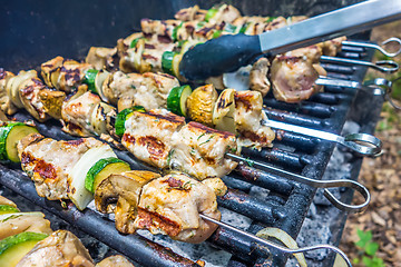 Image showing steak shishkabob skewers with vegitables cooking on flaming gril