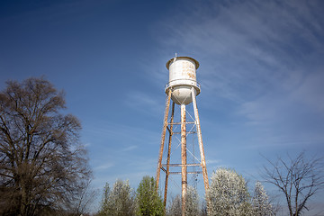 Image showing Tall  water tower with cloudy blue sky background