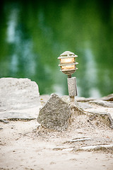 Image showing mood lighting light fixture on rocks by the water