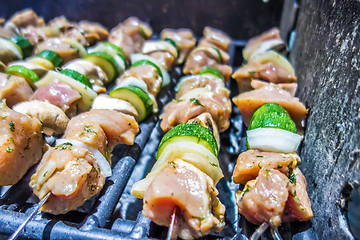 Image showing shish kebab on skewers on a grill on a holiday