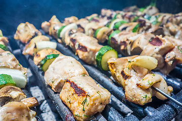 Image showing shish kebab on skewers on a grill on a holiday