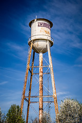 Image showing Tall  water tower with cloudy blue sky background