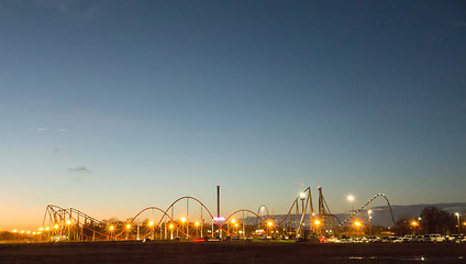 Image showing sunset over an amusement park in a distance