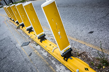 Image showing yellow reflective cones set up to direct traffic