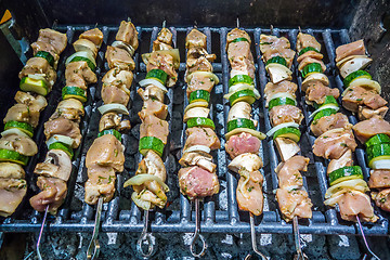 Image showing shish kebab on skewers on a grill on a holiday