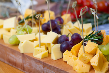 Image showing Cheese and grape on the wooden board