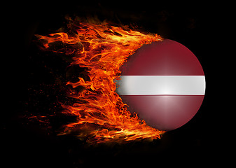 Image showing Flag with a trail of fire - Latvia