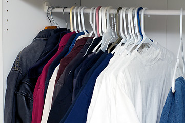 Image showing jackets and shirts inside closet