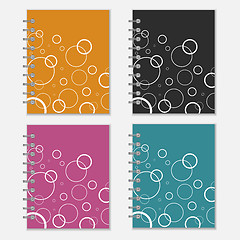 Image showing Set of four colorful notebook covers with white circles