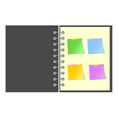 Image showing Open grey cover notebook with stickers