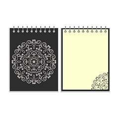 Image showing Black cover notebook with round floral pattern