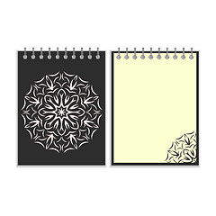 Image showing Black cover notebook with round florwer pattern