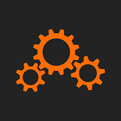 Image showing Three orange gear wheels on black