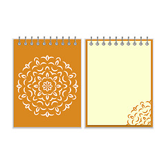 Image showing Spiral orange cover notebook with round ornate pattern