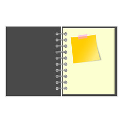 Image showing Open grey cover notebook with yellow sticker