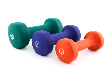 Image showing Three colorful dumbbells of different size