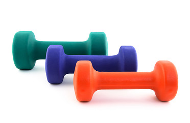 Image showing Three dumbbells of different colors