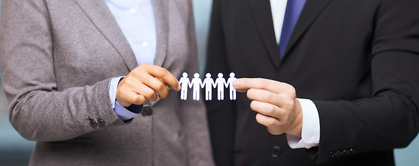 Image showing businessman and businesswoman holding paper team