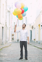 Image showing man with colorful balloons in the city