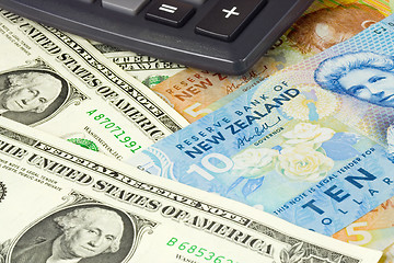 Image showing Forex - US and New Zealand currency pair with calculator

