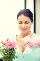 Image showing lovely housewife with flower