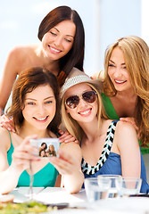 Image showing girls taking photo in cafe on the beach