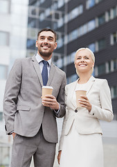 Image showing smiling businessmen with paper cups outdoors