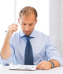 Image showing businessman writing in notebook