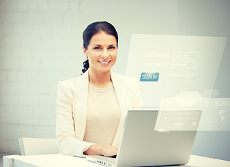 Image showing woman with laptop computer and virtual screen