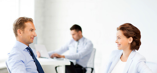 Image showing man and woman discussing something in office