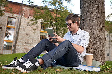 Image showing happy teenage boy with tablet pc and coffee
