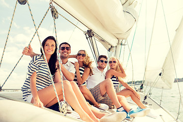 Image showing smiling friends sitting on yacht deck